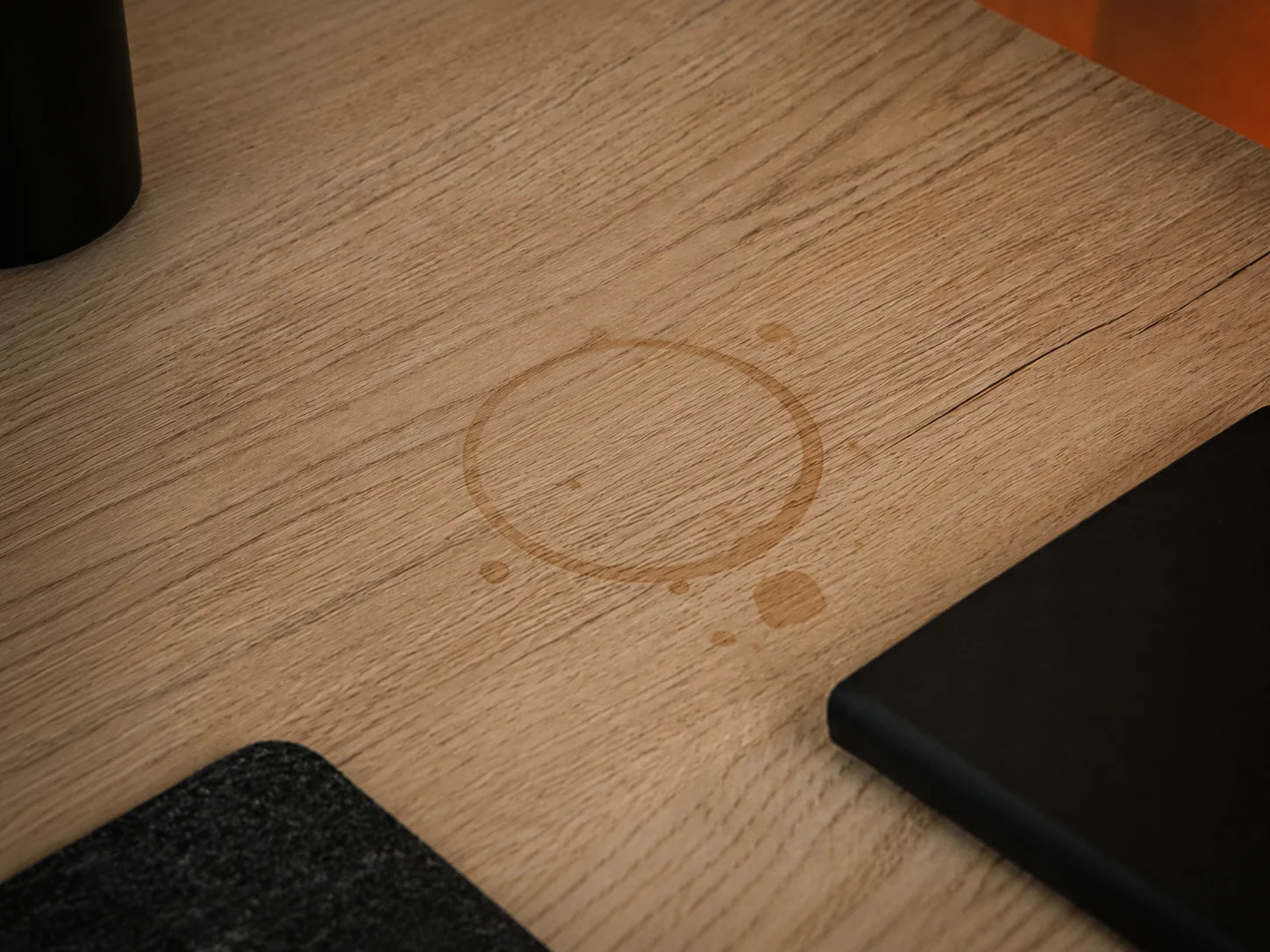 Ortus Felt Coasters in black felt on a desk