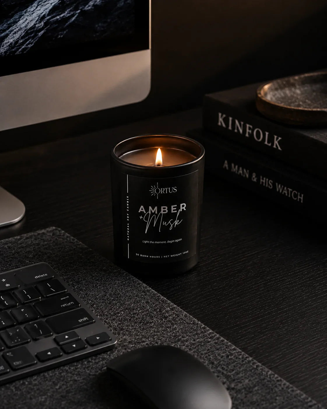 Ortus black candle on a desk