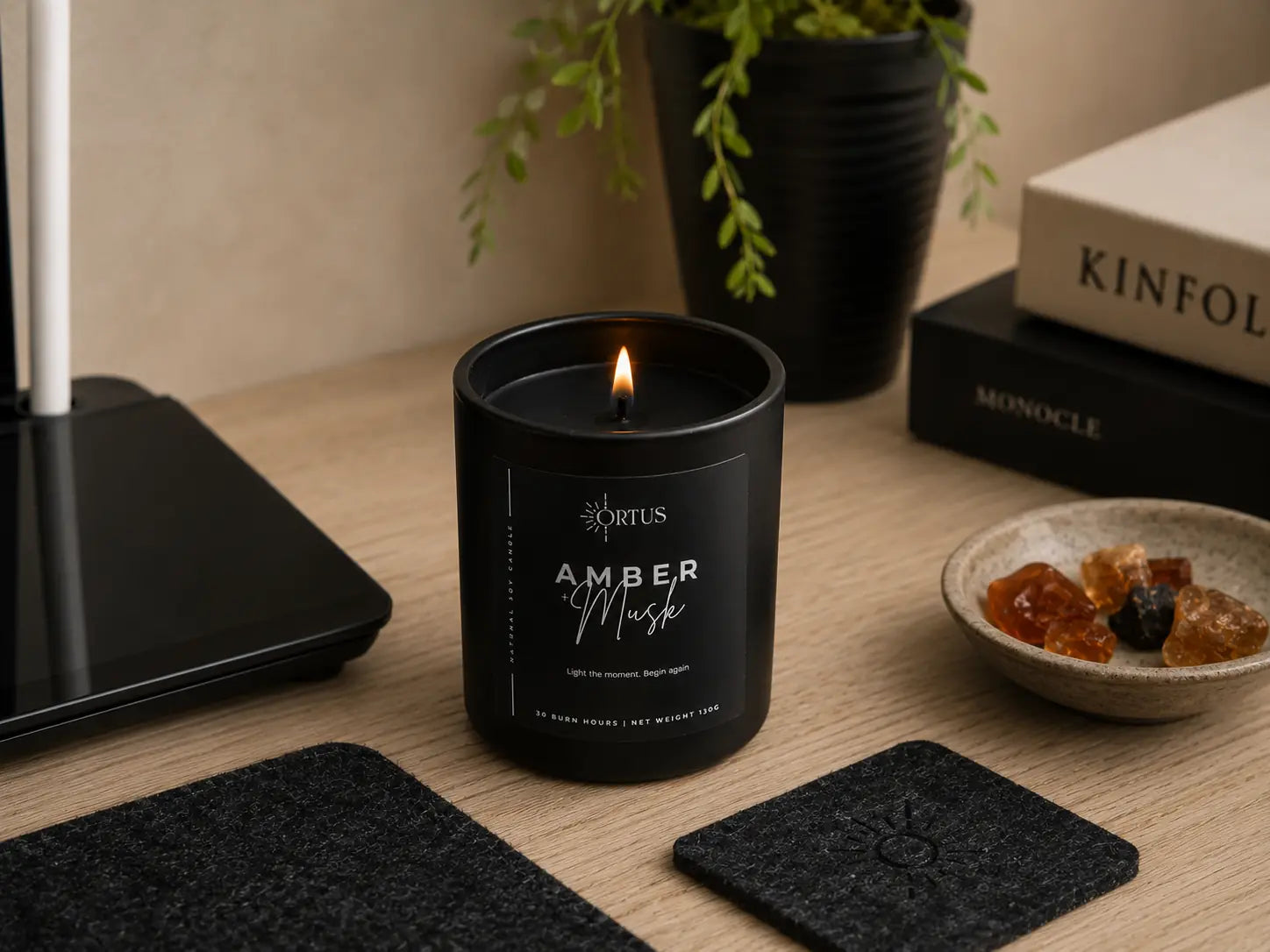 Ortus black minimal scented candle on a desk